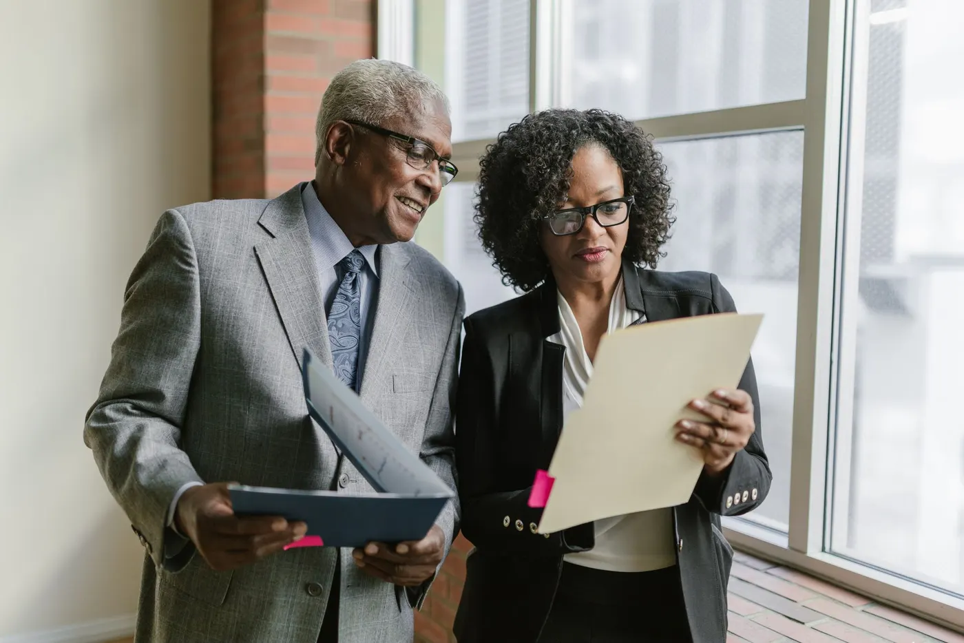 Two investment advisors reviewing a client portfolio together